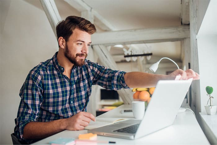 a male having his Telehealth consultation from his laptop