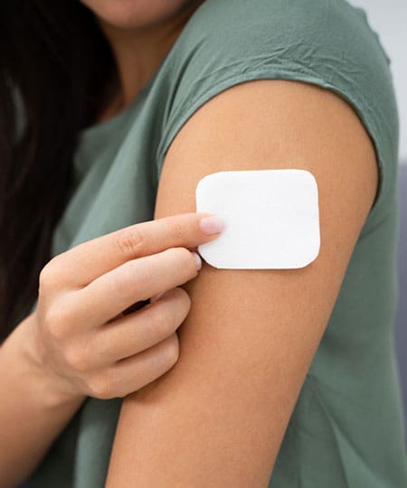 a female showing her bandage after getting vaccination
