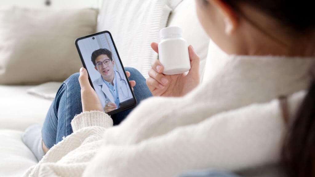 Patient discussing medication with doctor over online Telehealth consultation