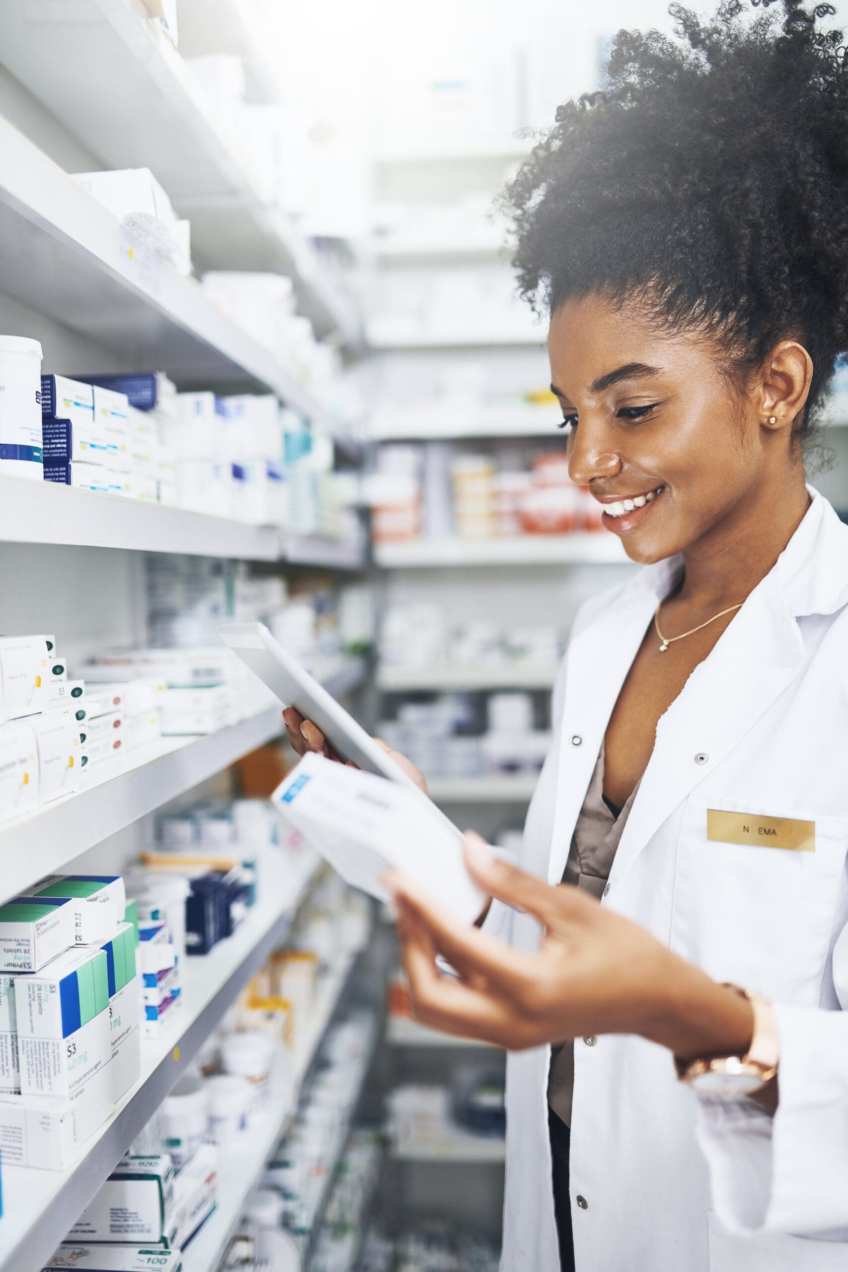 pharmacist checking script orders and medication in a pharmacy store